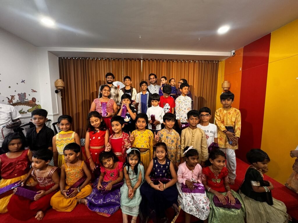 Kids and mentors celebrating at Jignasa Spotlight stage performance event in Nallagandla